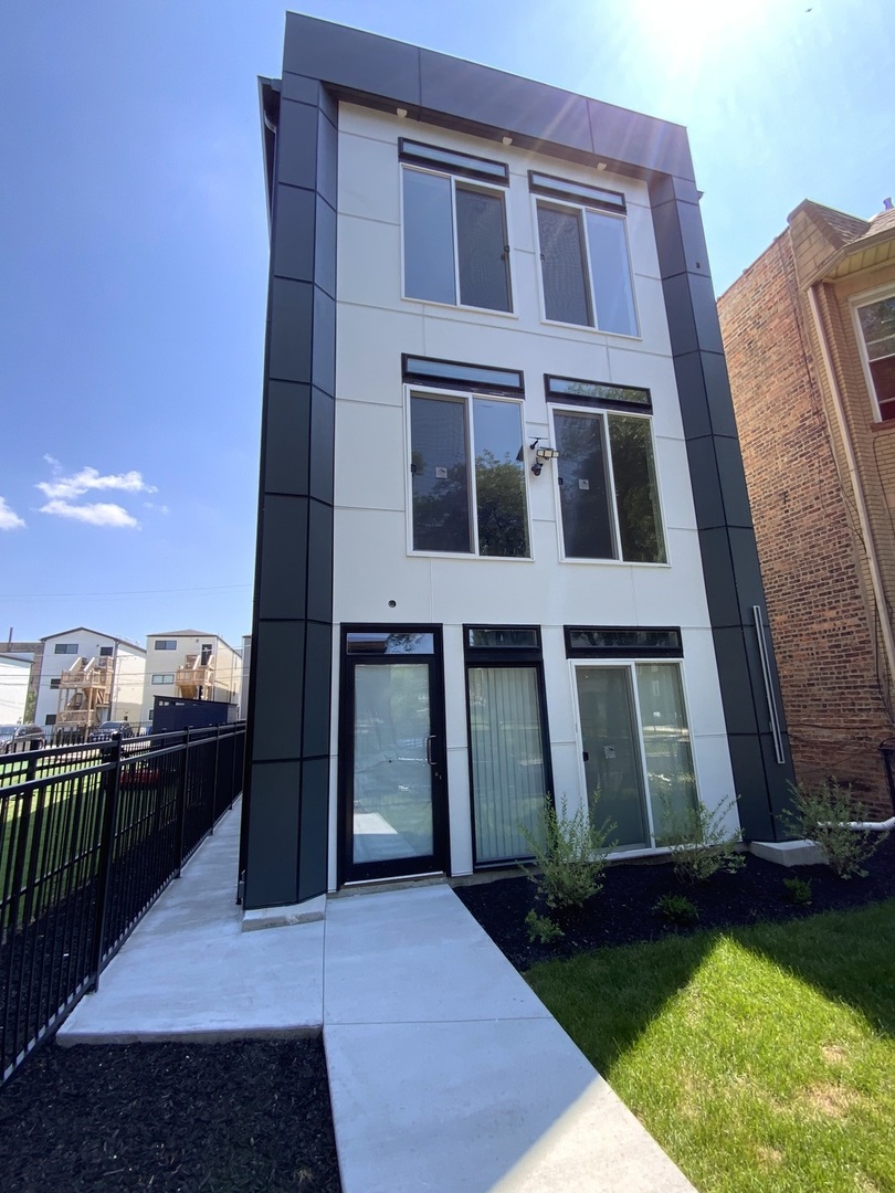 6327 South Langley Avenue, Unit 2 Chicago, IL 60637 - Photo 10 of 10 a view of a brick house with many windows