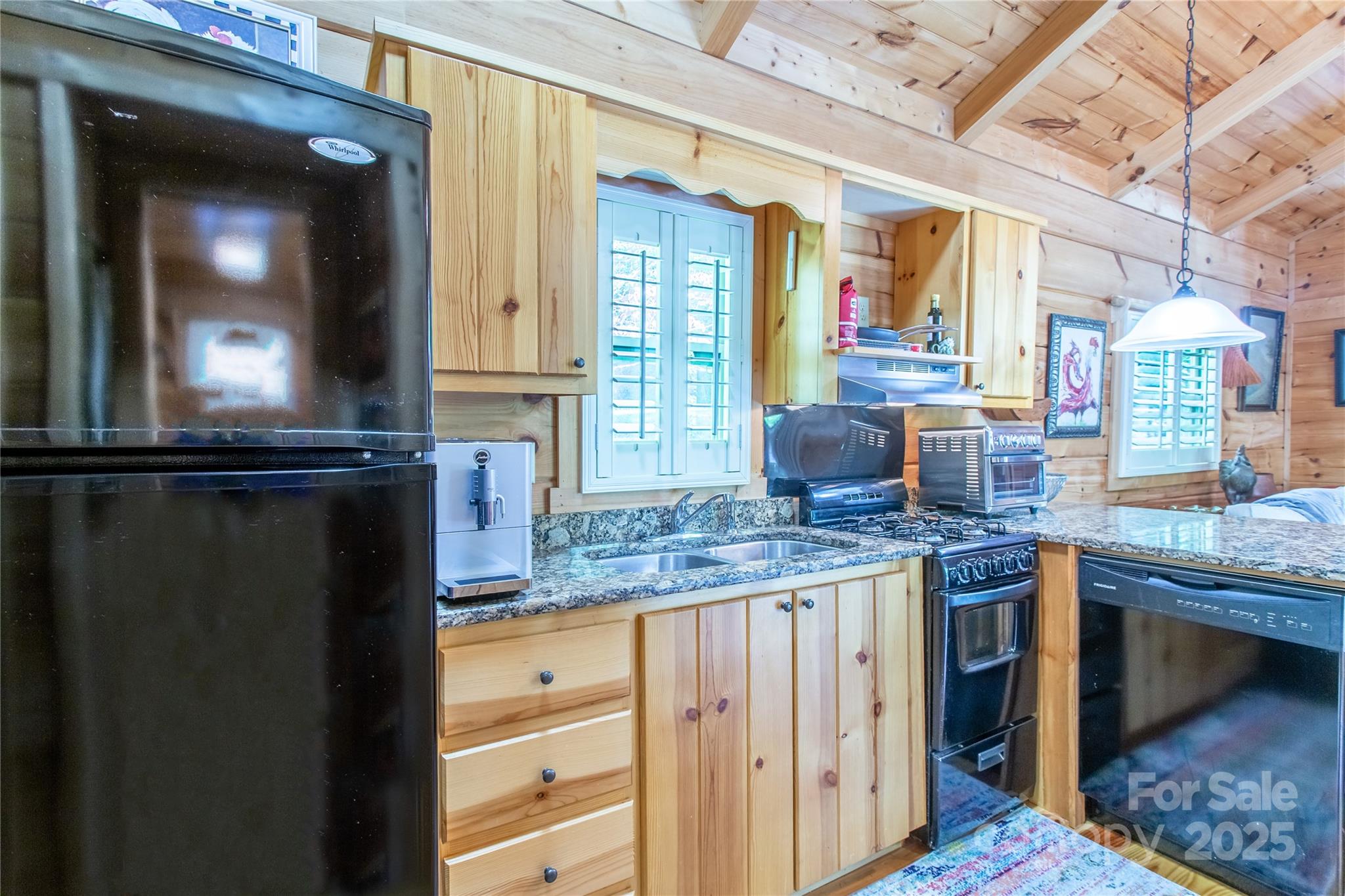 202 Duke Franklin Road Spruce Pine, NC 28777 - Photo 11 of 34 a kitchen with granite countertop a stove and cabinets