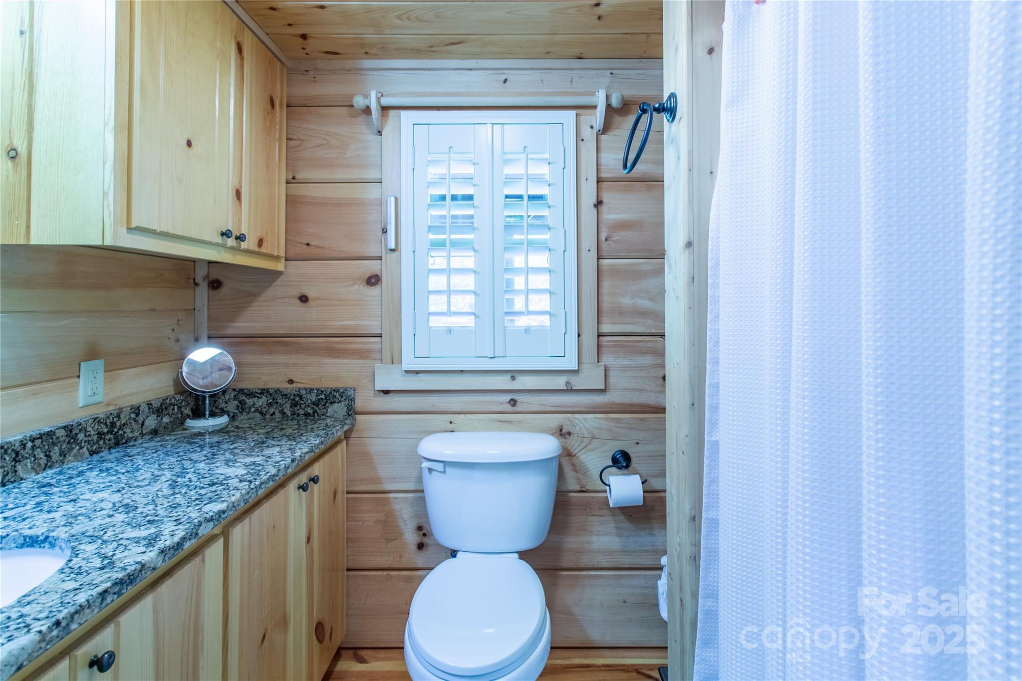 202 Duke Franklin Road Spruce Pine, NC 28777 - Photo 13 of 34 a bathroom with a granite countertop toilet sink and mirror