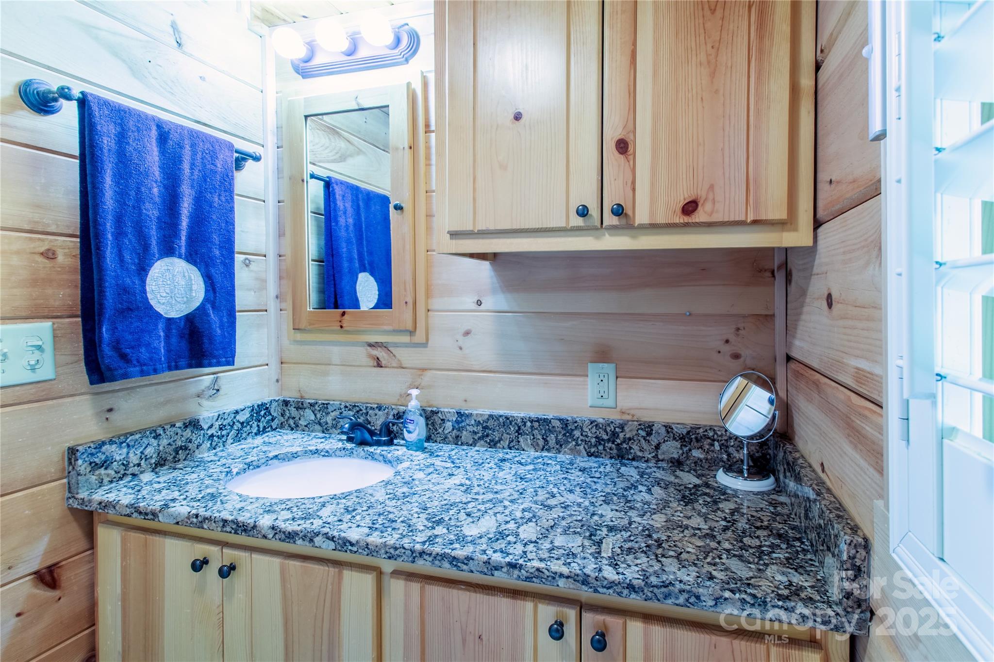 202 Duke Franklin Road Spruce Pine, NC 28777 - Photo 14 of 34 a bathroom with a granite countertop sink and a mirror