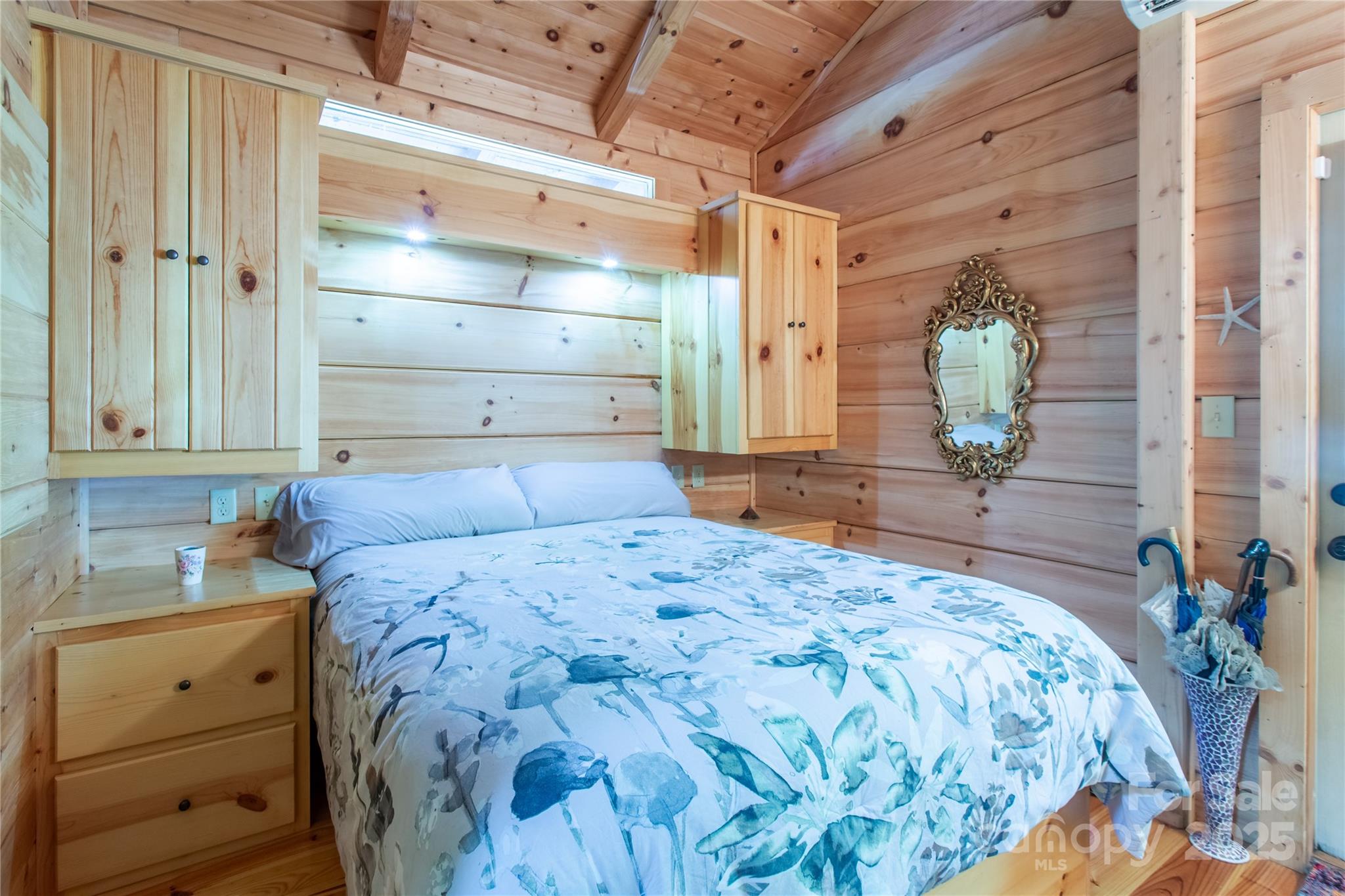 202 Duke Franklin Road Spruce Pine, NC 28777 - Photo 15 of 34 a bedroom with a bed and a mirror