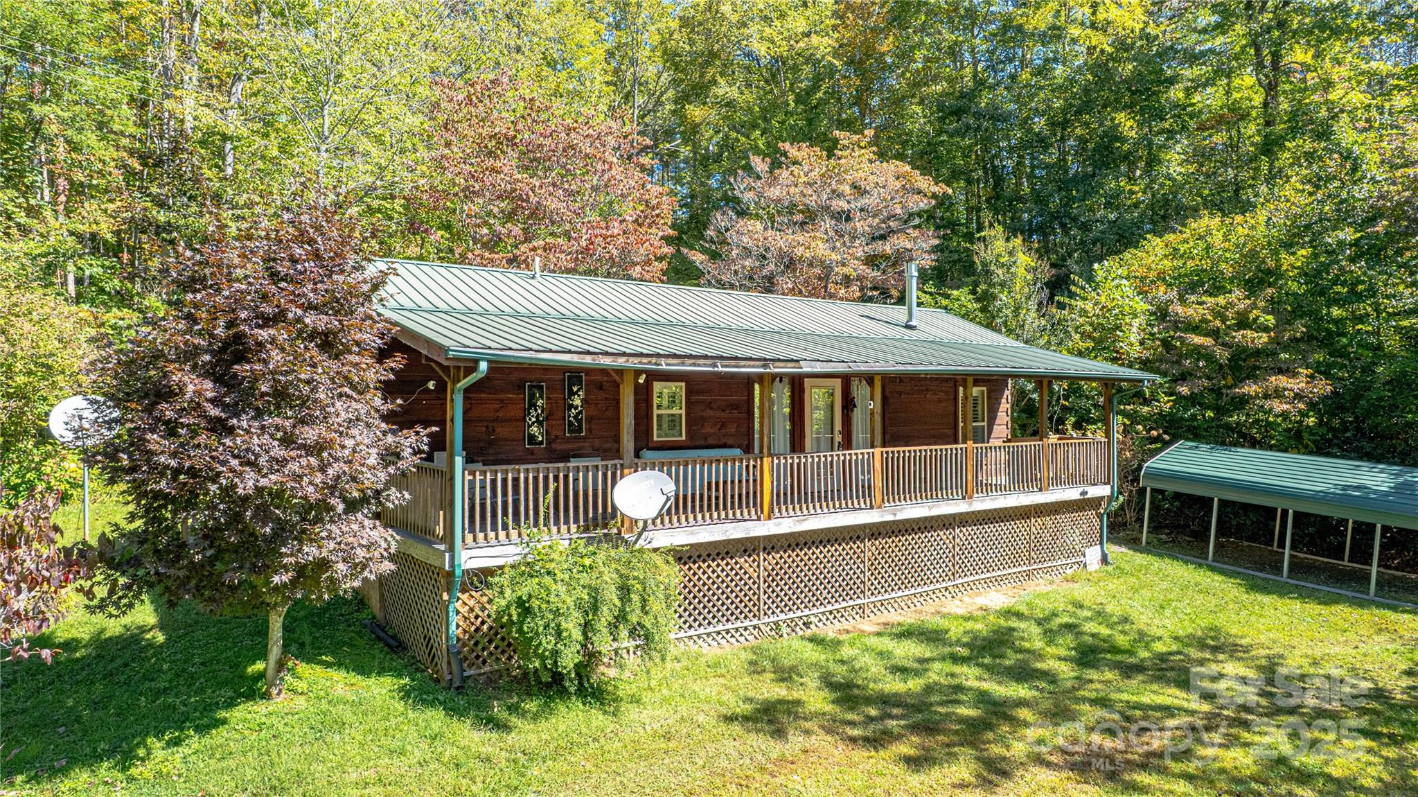 202 Duke Franklin Road Spruce Pine, NC 28777 - Photo 3 of 34 a house with trees in the background