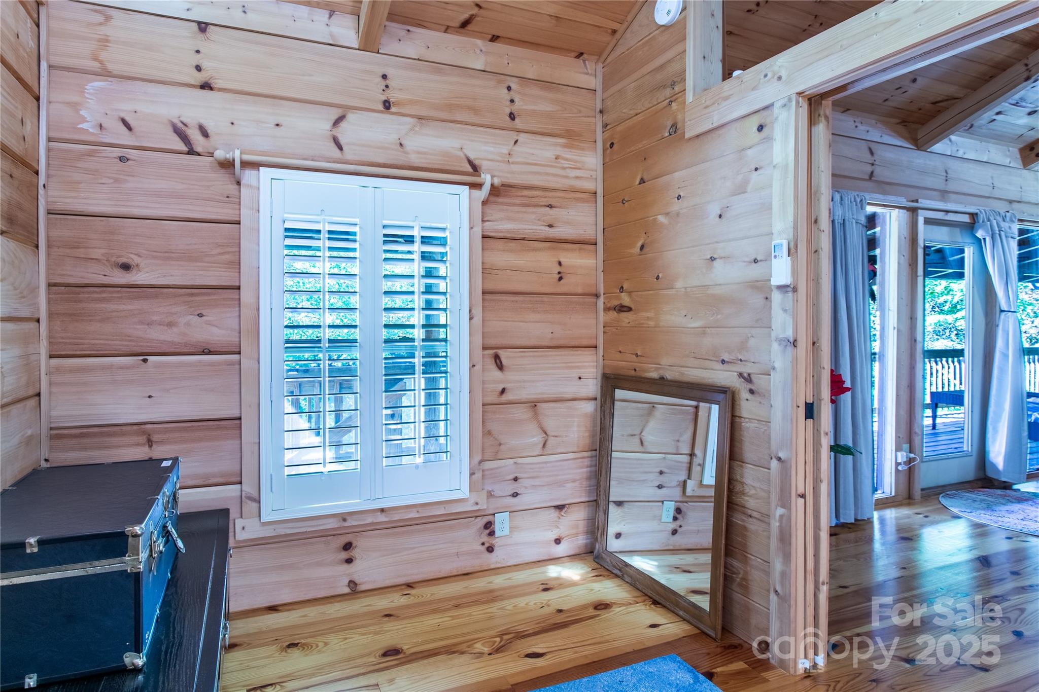 202 Duke Franklin Road Spruce Pine, NC 28777 - Photo 8 of 34 a view of a bedroom with a window and wooden floor