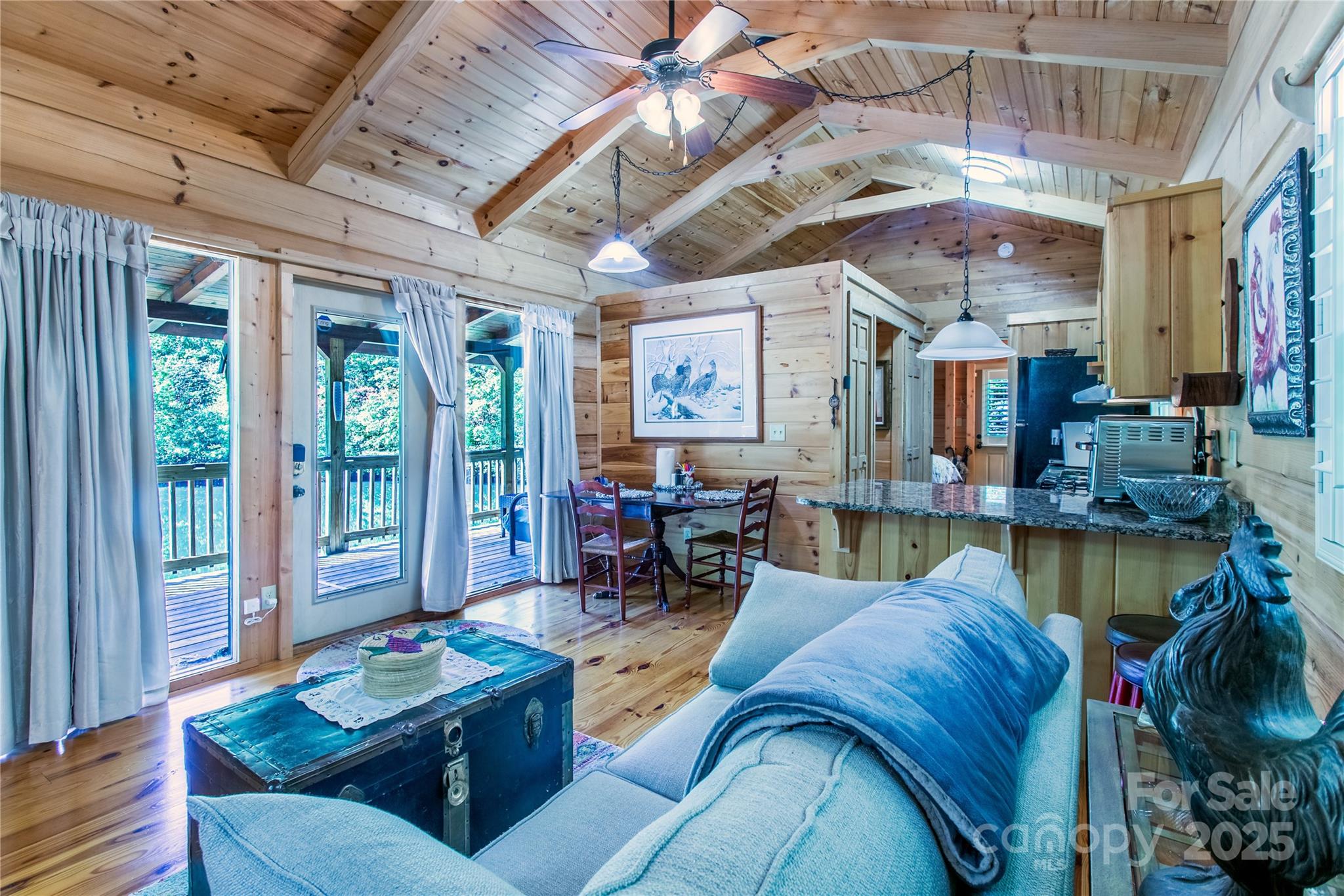 202 Duke Franklin Road Spruce Pine, NC 28777 - Photo 10 of 34 a living room with furniture and a chandelier