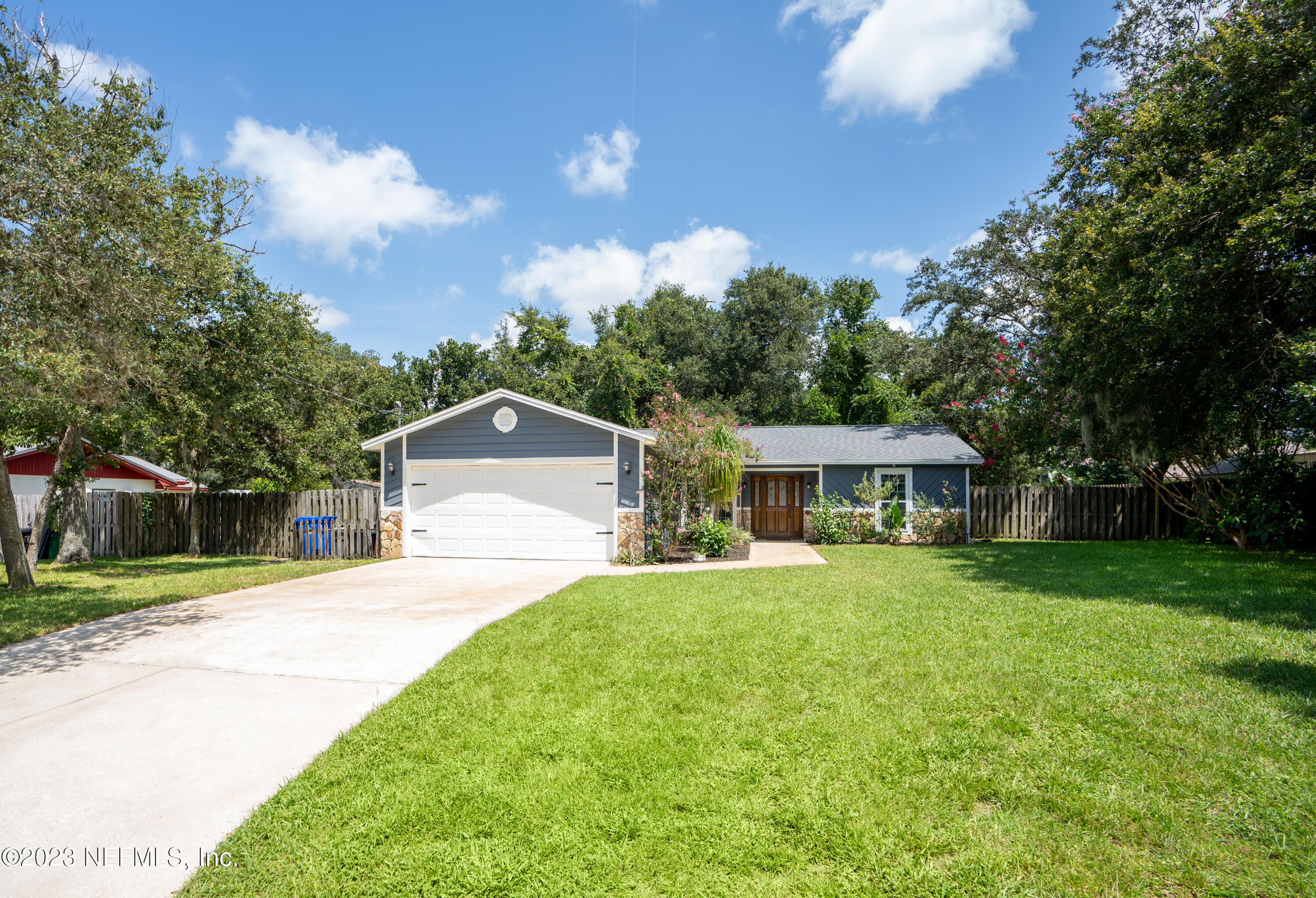 107 Heron Road St. Augustine, FL 32086 - Photo 1 of 39 a front view of a house with a yard and trees
