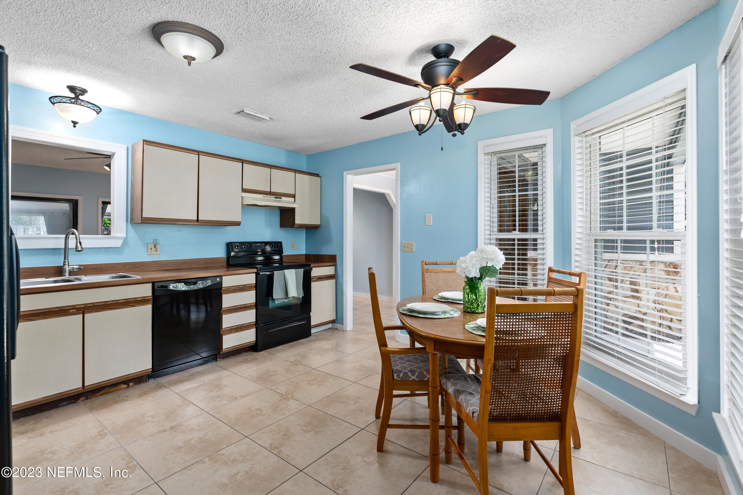107 Heron Road St. Augustine, FL 32086 - Photo 11 of 39 a kitchen with granite countertop wooden cabinets a counter top space and stainless steel appliances