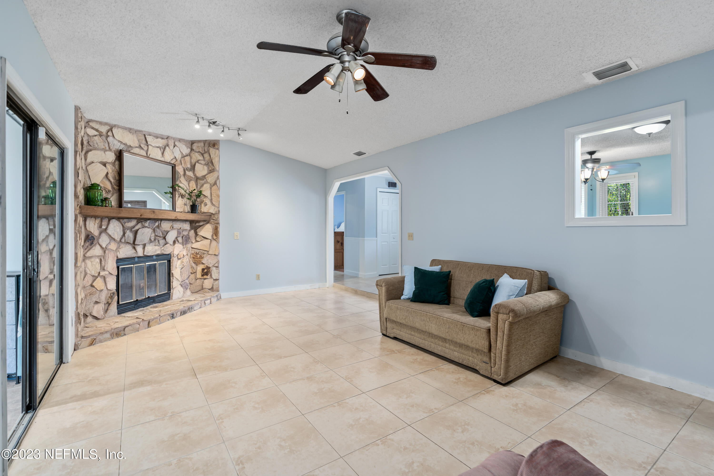 107 Heron Road St. Augustine, FL 32086 - Photo 14 of 39 a living room with furniture and a fireplace