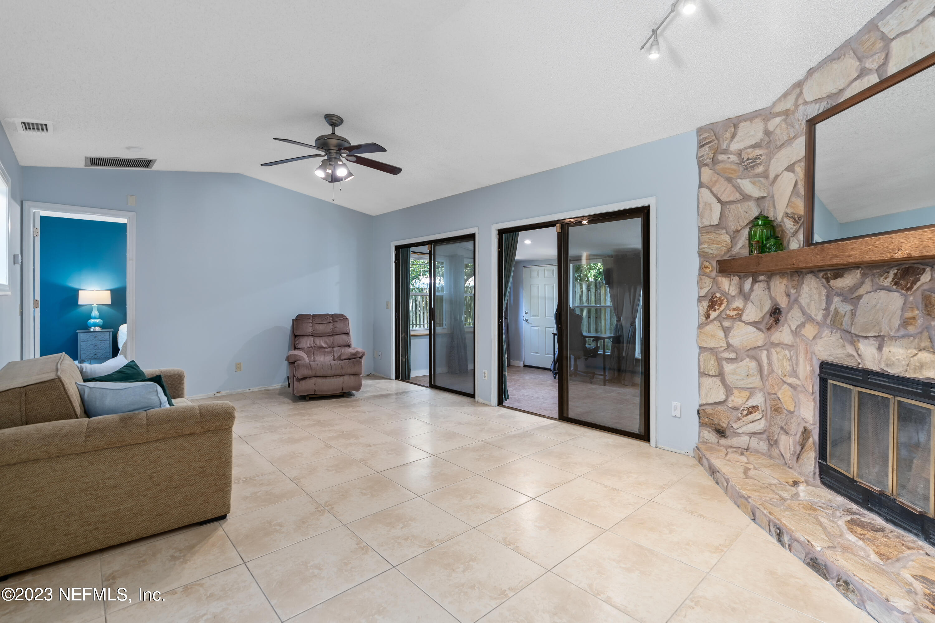 107 Heron Road St. Augustine, FL 32086 - Photo 15 of 39 a living room with furniture and a fireplace