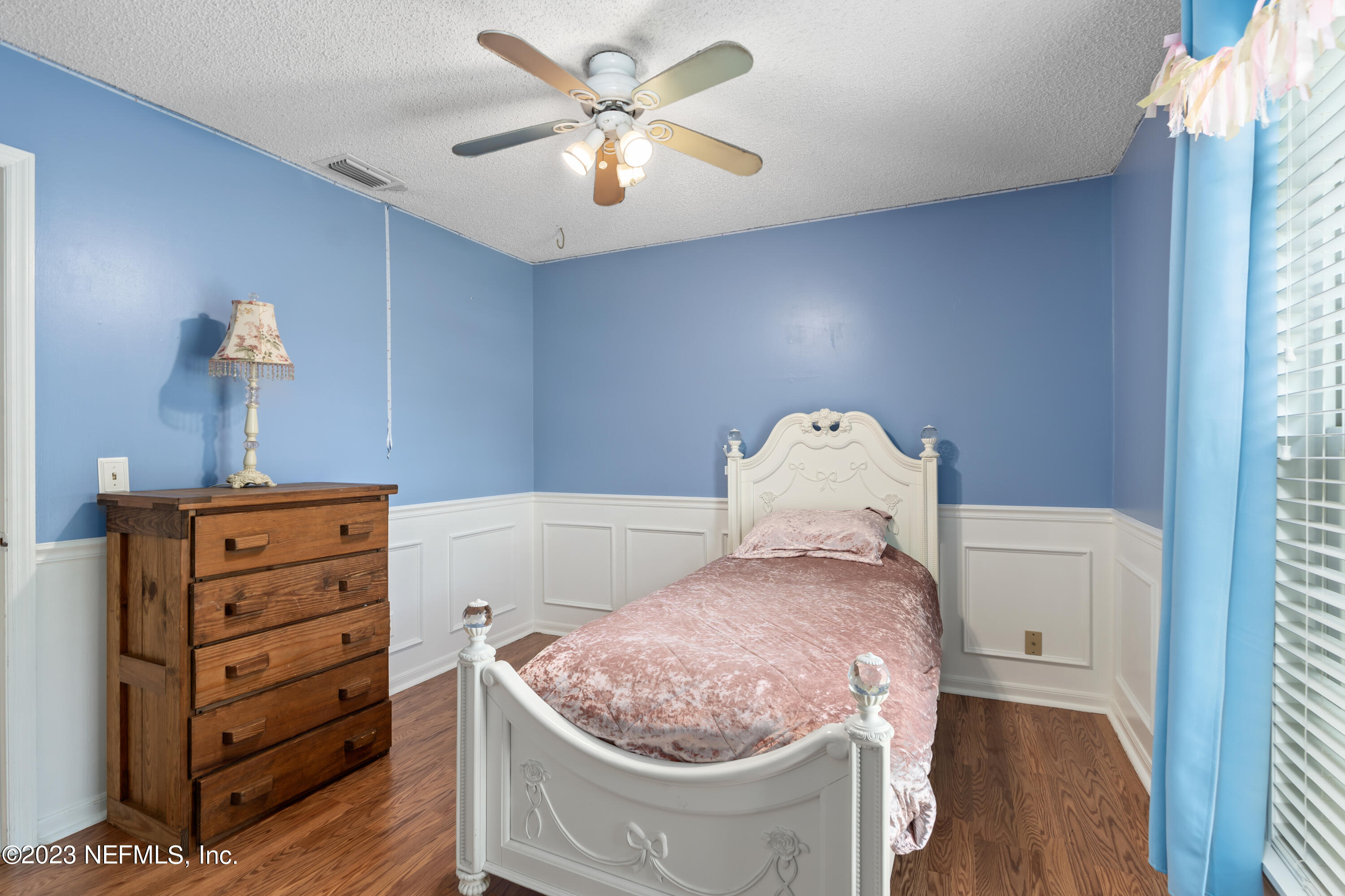 107 Heron Road St. Augustine, FL 32086 - Photo 17 of 39 a bedroom with a bed and a chandelier