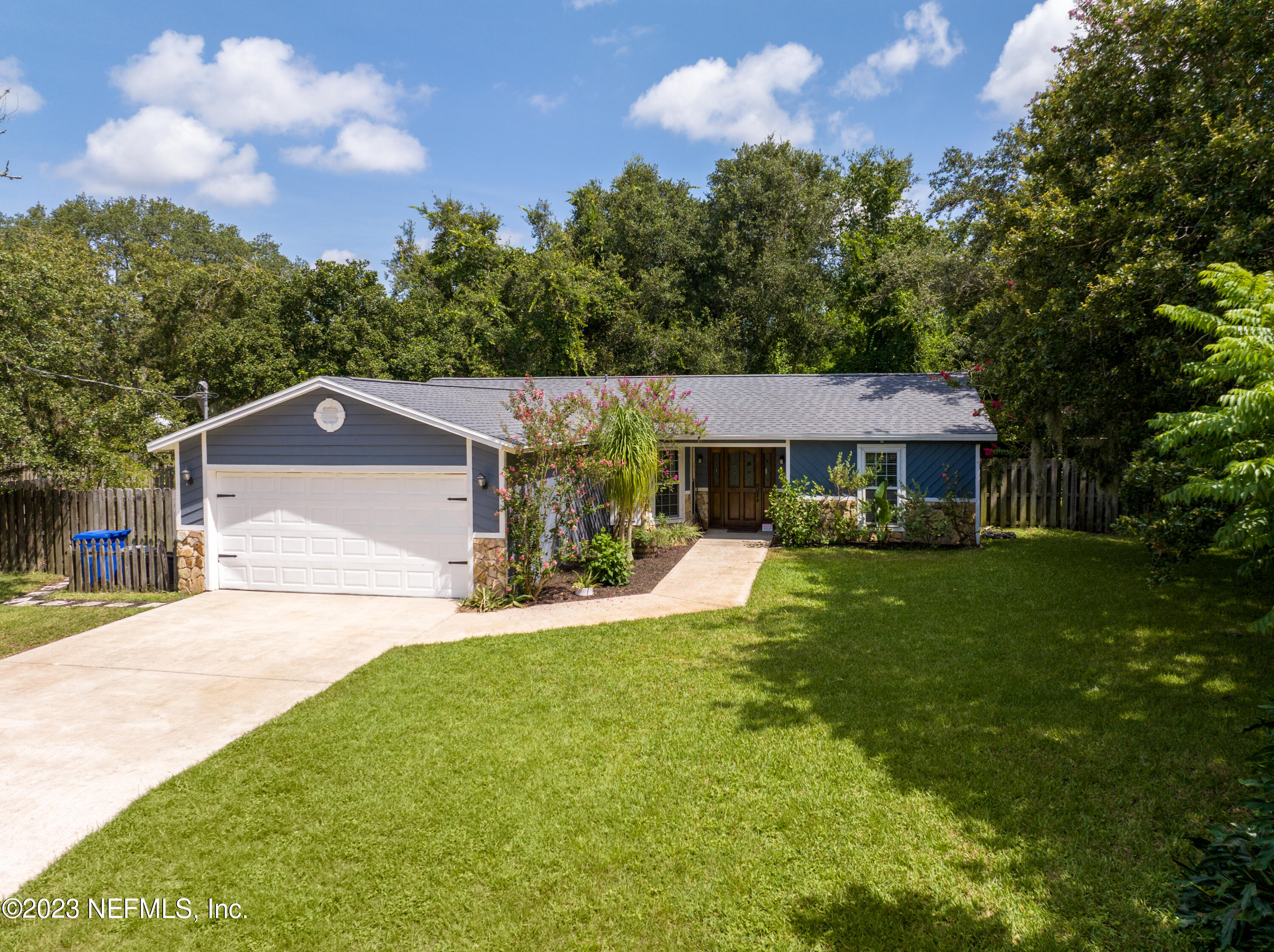 107 Heron Road St. Augustine, FL 32086 - Photo 2 of 39 a front view of a house with a yard and garage