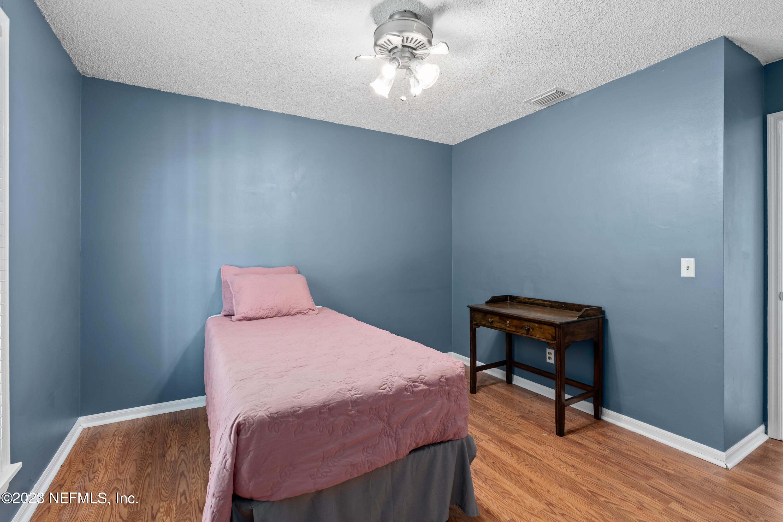 107 Heron Road St. Augustine, FL 32086 - Photo 21 of 39 a bedroom with a bed a desk and chair