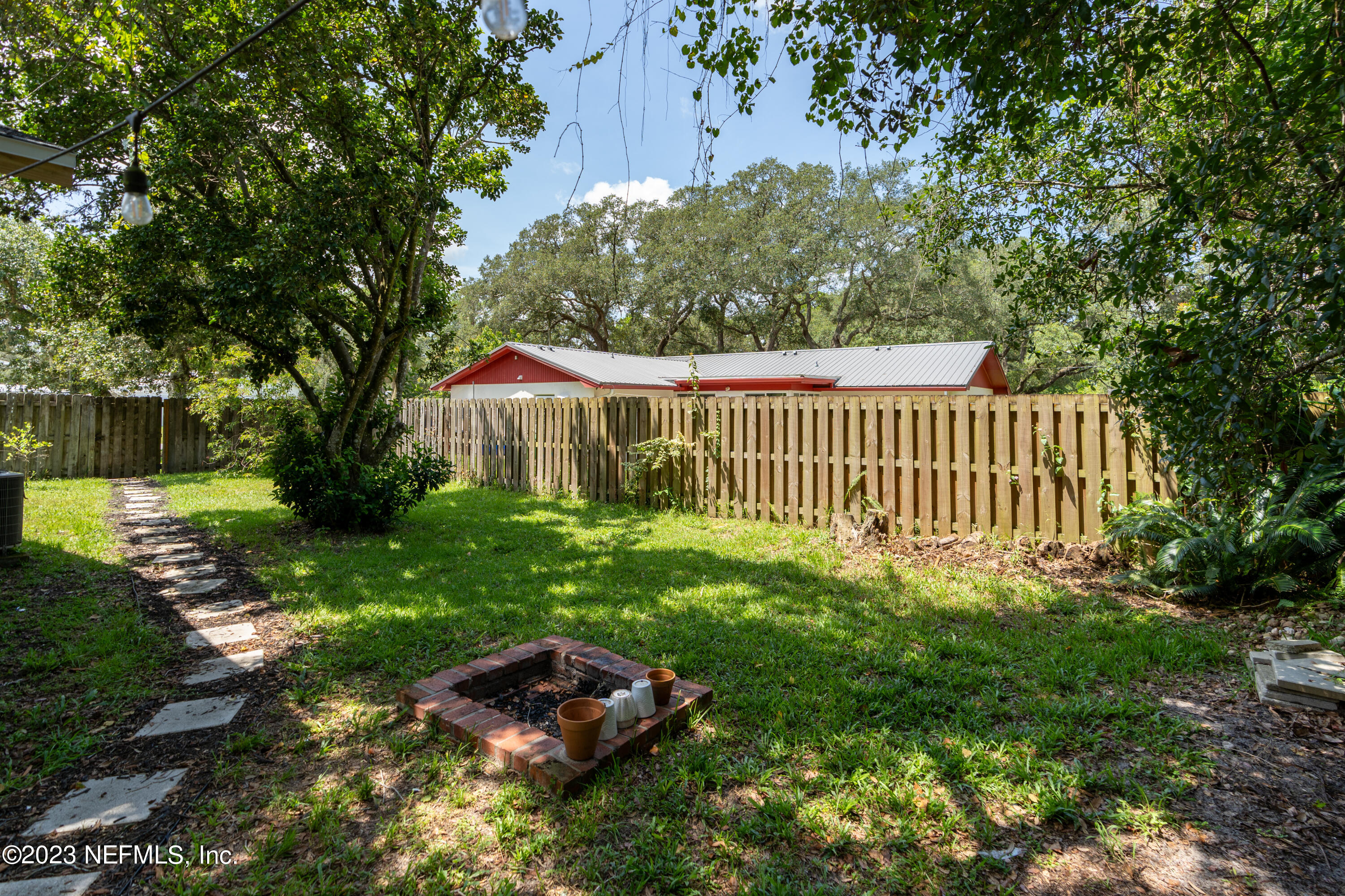 107 Heron Road St. Augustine, FL 32086 - Photo 24 of 39 a view of a garden with a bench