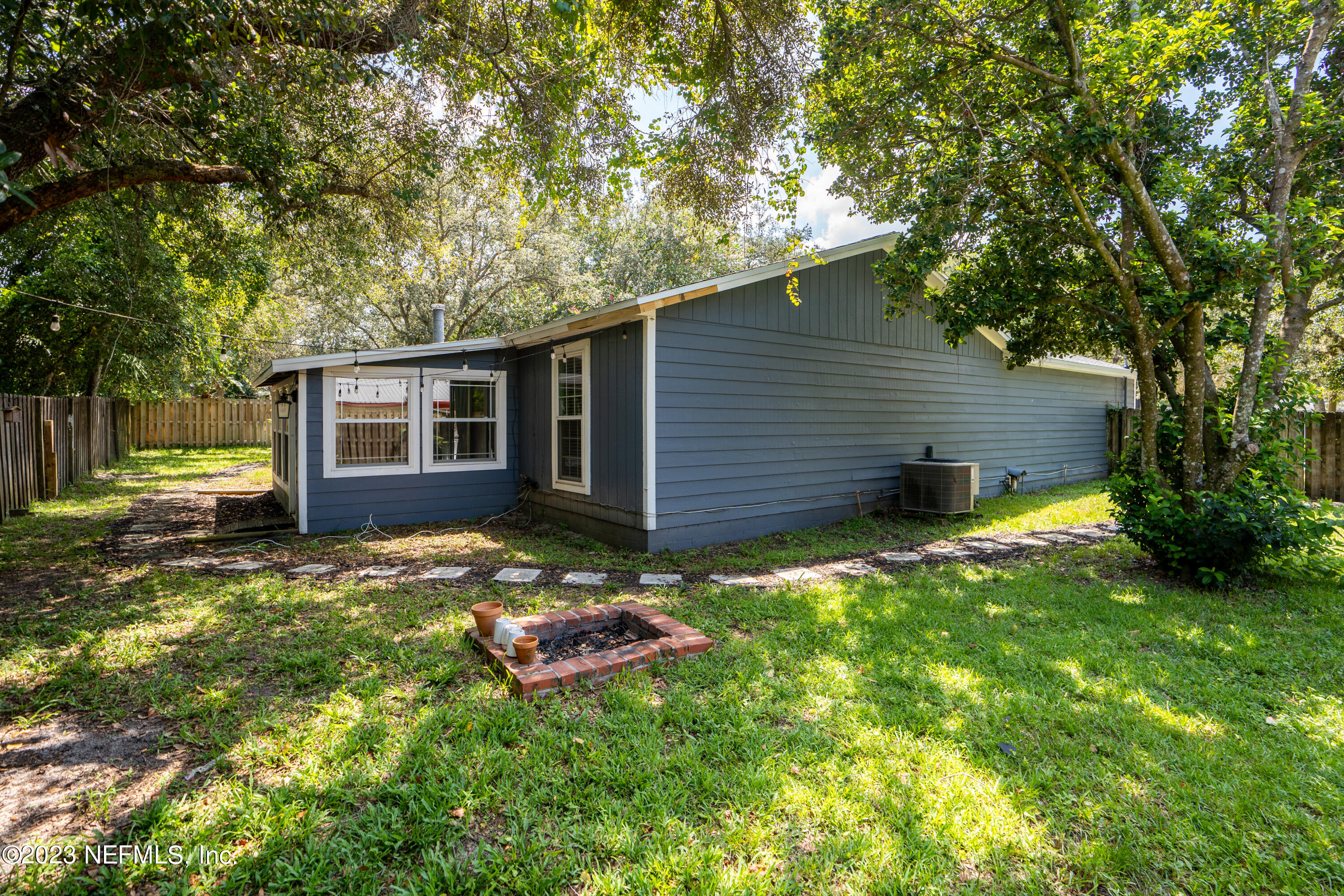 107 Heron Road St. Augustine, FL 32086 - Photo 25 of 39 a backyard of a house with barbeque oven table and chairs