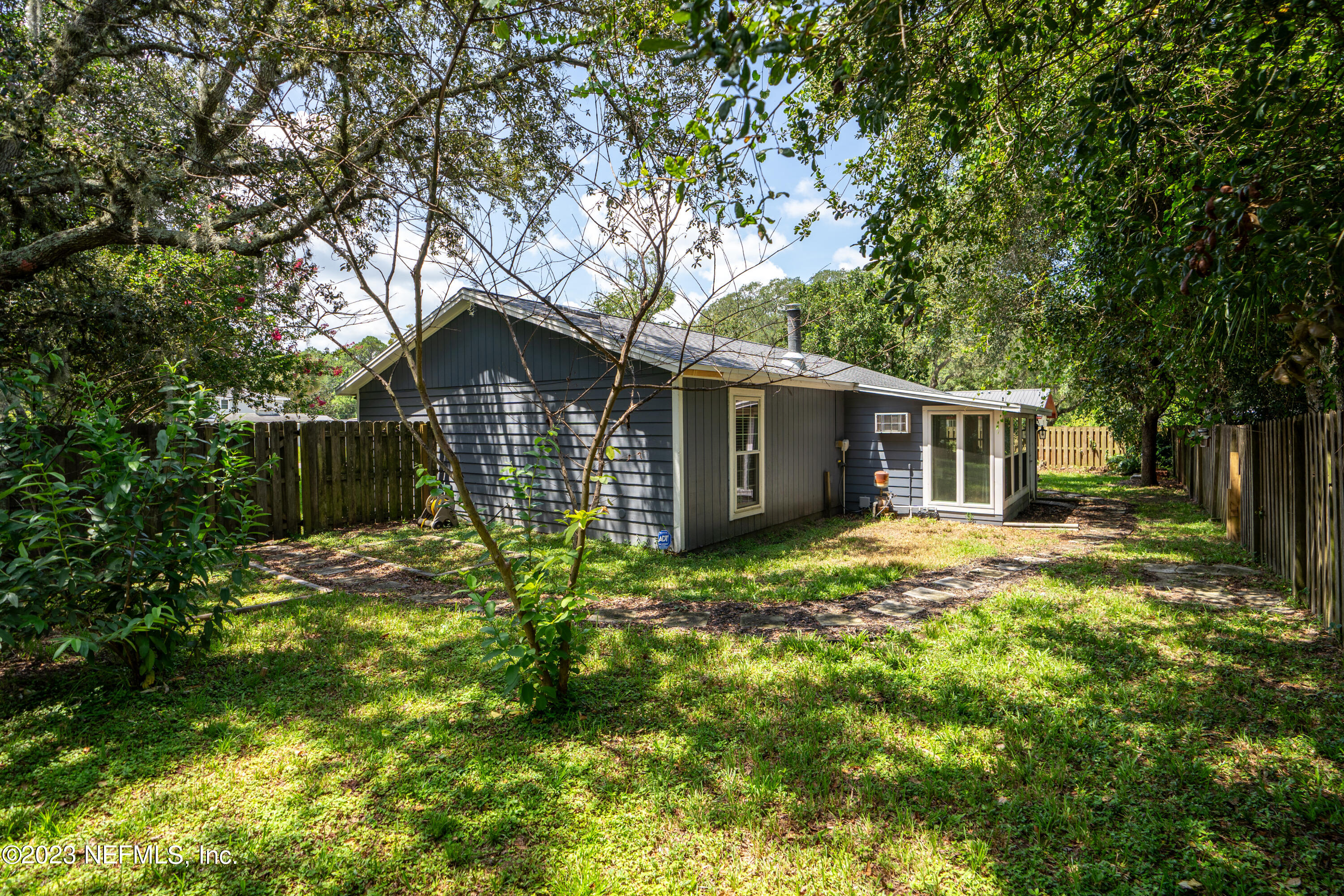 107 Heron Road St. Augustine, FL 32086 - Photo 26 of 39 a backyard of a house with table and sofas