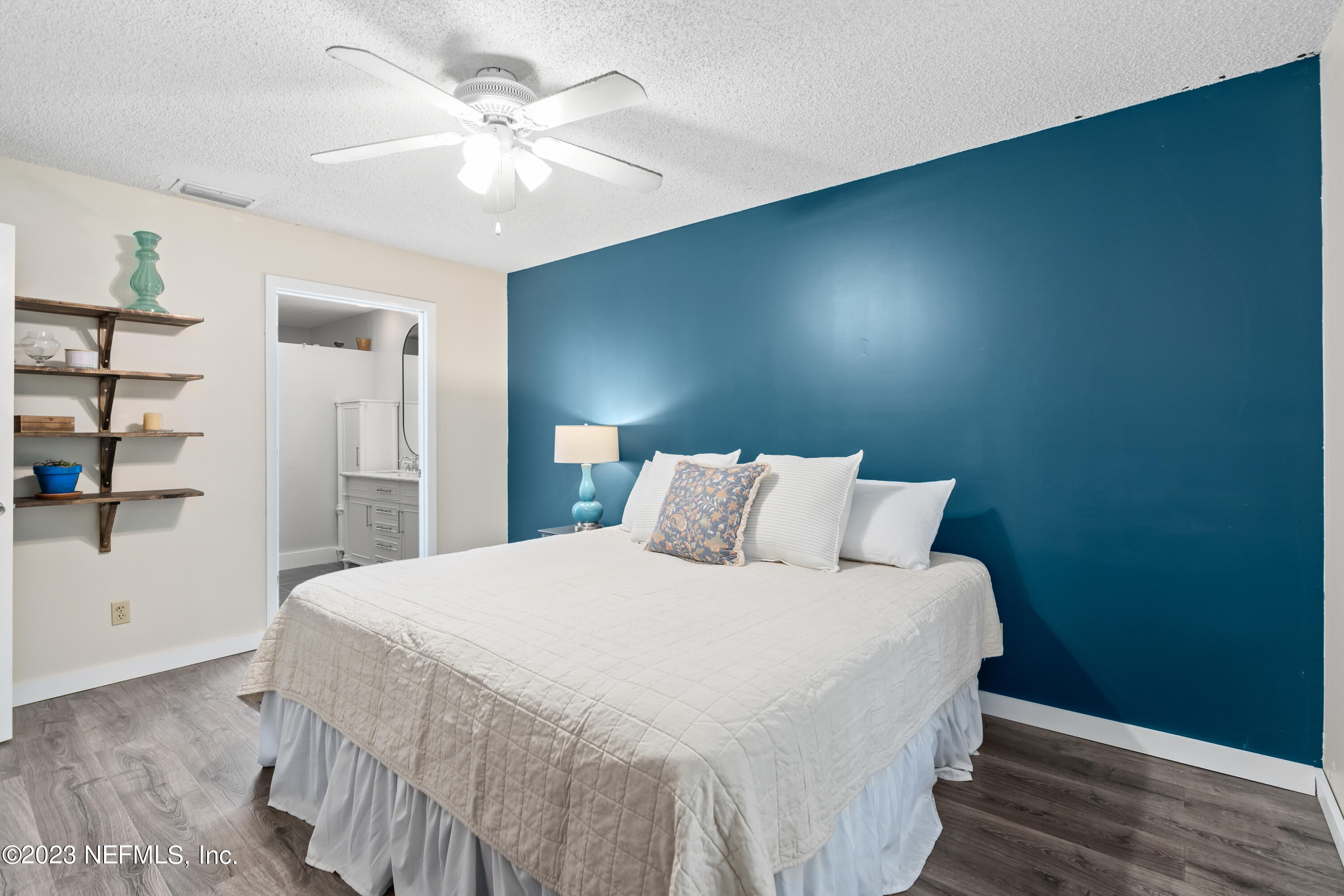 107 Heron Road St. Augustine, FL 32086 - Photo 6 of 39 a bedroom with a large bed and a chandelier