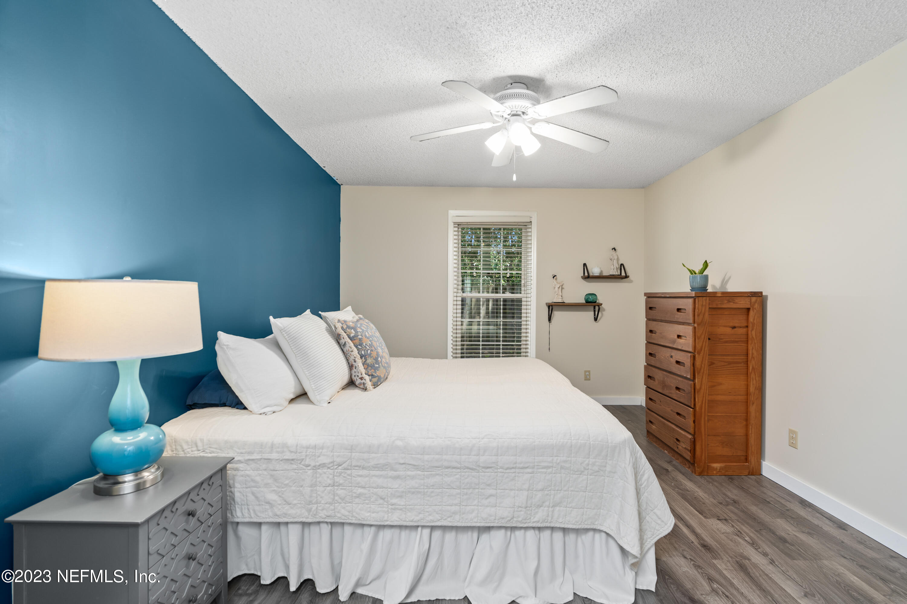 107 Heron Road St. Augustine, FL 32086 - Photo 7 of 39 a bedroom with a large bed and a chandelier