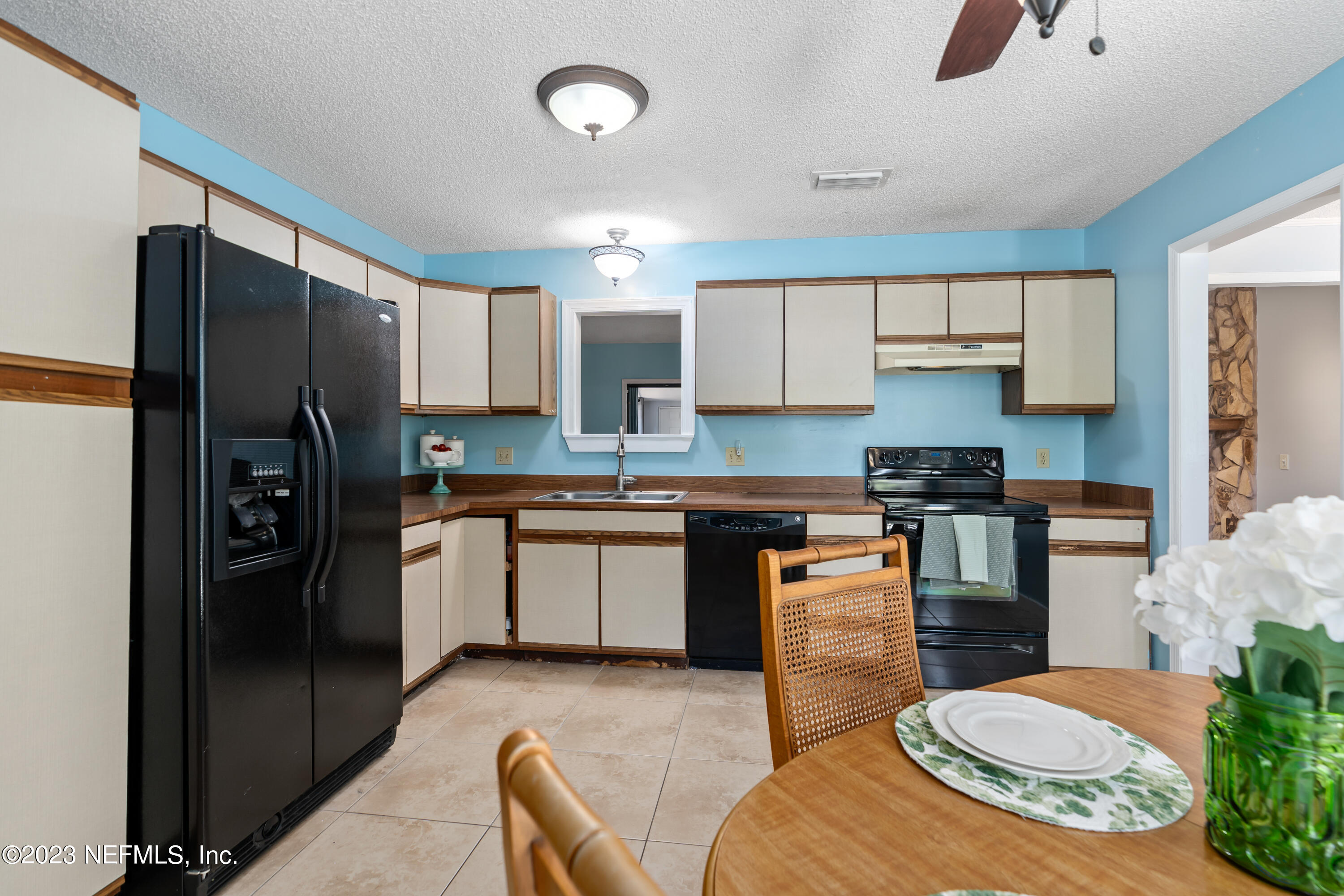 107 Heron Road St. Augustine, FL 32086 - Photo 10 of 39 a kitchen with stainless steel appliances kitchen island granite countertop a refrigerator stove top oven and sink