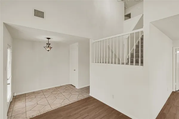 a view of hallway with wooden floor