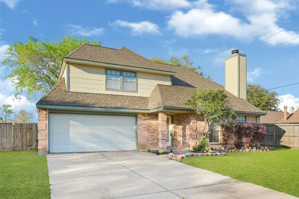 a front view of a house with a garden and plants