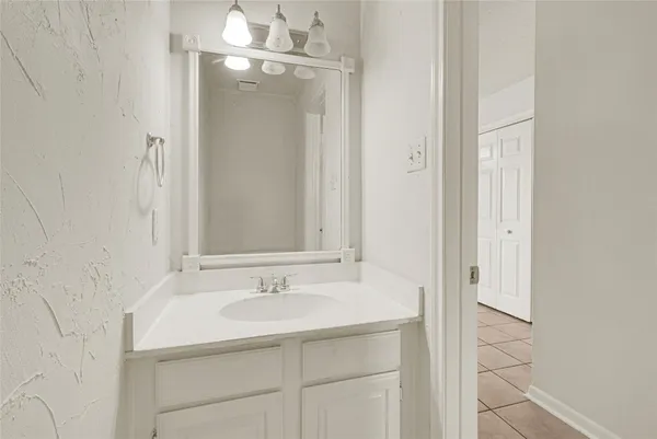 a bathroom with a sink and mirror
