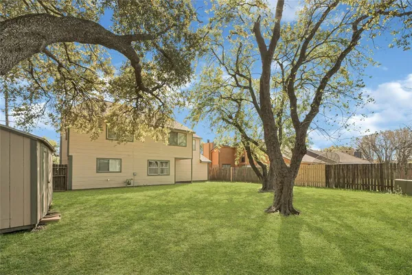 a view of a house with a tree in the background