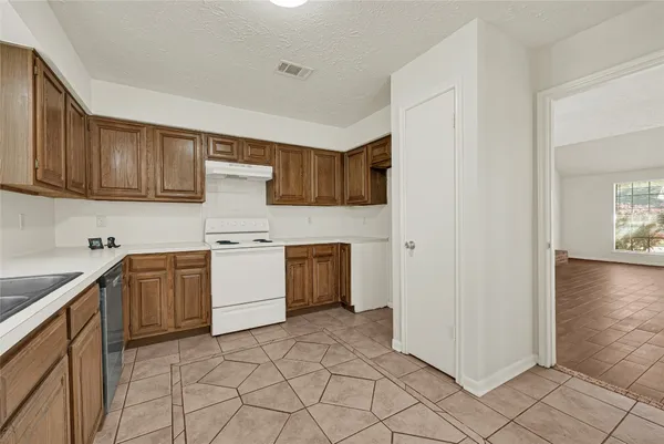 a kitchen with a stove top oven sink and cabinets