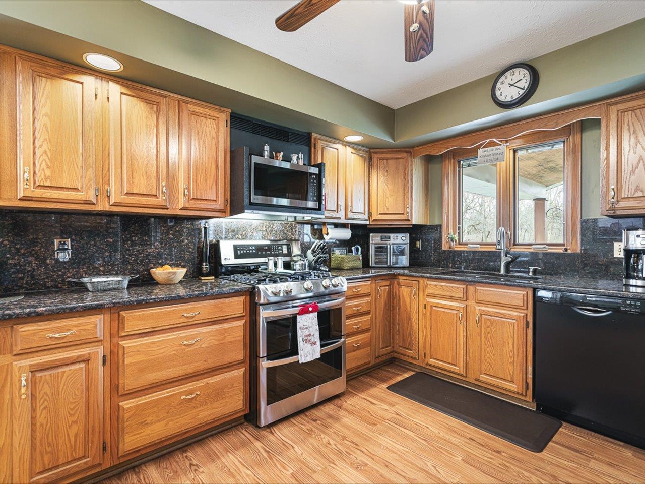 9744 Prairie Lane Belvidere, IL 61008 - Photo 19 of 66 a kitchen with stainless steel appliances granite countertop wooden cabinets a sink and a stove