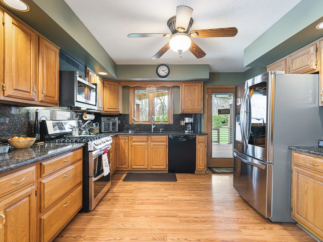 9744 Prairie Lane Belvidere, IL 61008 - Photo 20 of 66 a large kitchen with stainless steel appliances granite countertop a stove cabinets and wooden floor