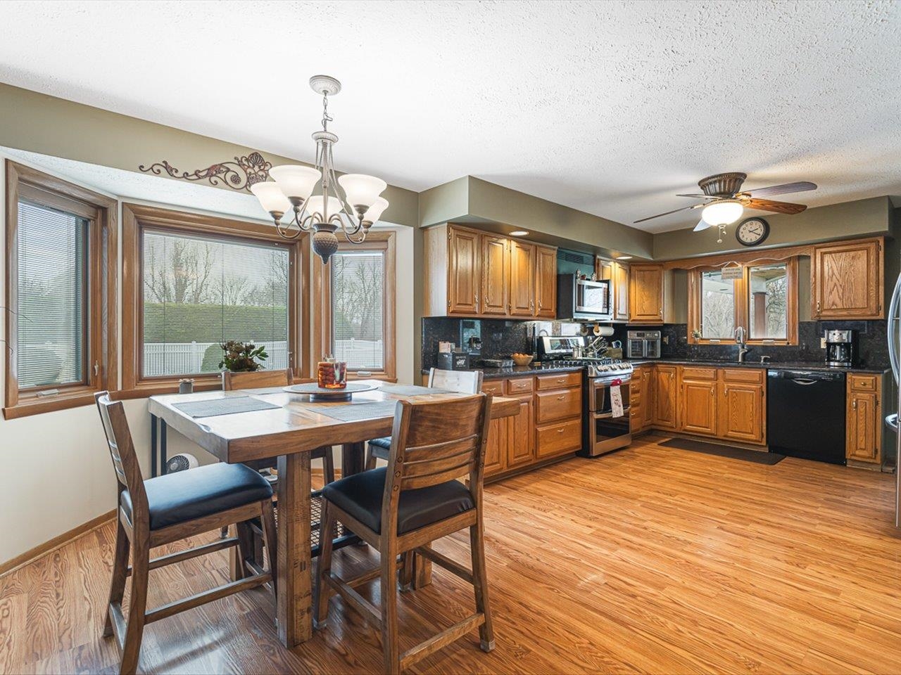 9744 Prairie Lane Belvidere, IL 61008 - Photo 21 of 66 a kitchen with a table chairs refrigerator and cabinets