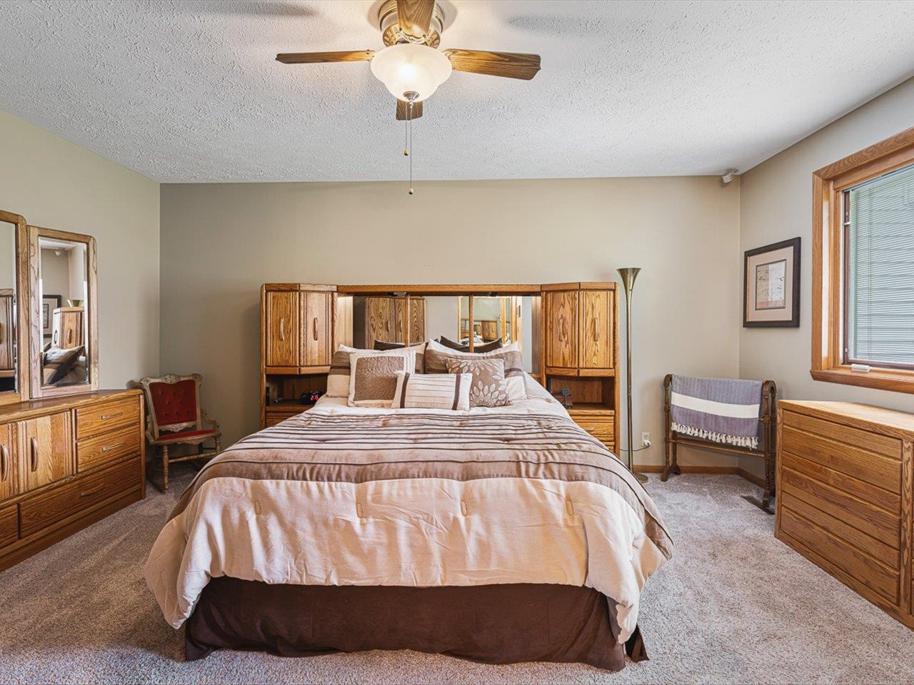 9744 Prairie Lane Belvidere, IL 61008 - Photo 24 of 66 a bed sitting in a bedroom next to a window with a dresser