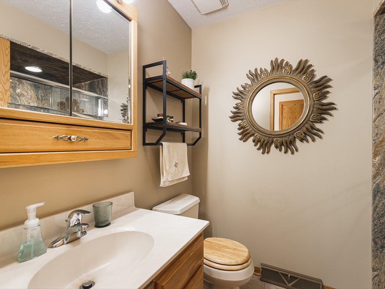 9744 Prairie Lane Belvidere, IL 61008 - Photo 26 of 66 a bathroom with a sink a toilet and a mirror