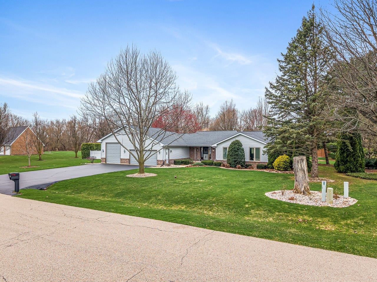 9744 Prairie Lane Belvidere, IL 61008 - Photo 3 of 66 a front view of a house with a garden and trees