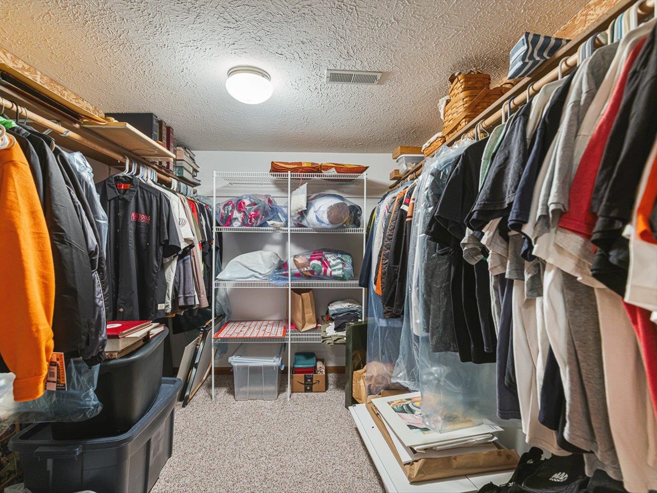 9744 Prairie Lane Belvidere, IL 61008 - Photo 41 of 66 a view of walk in closet with clothes and shoes