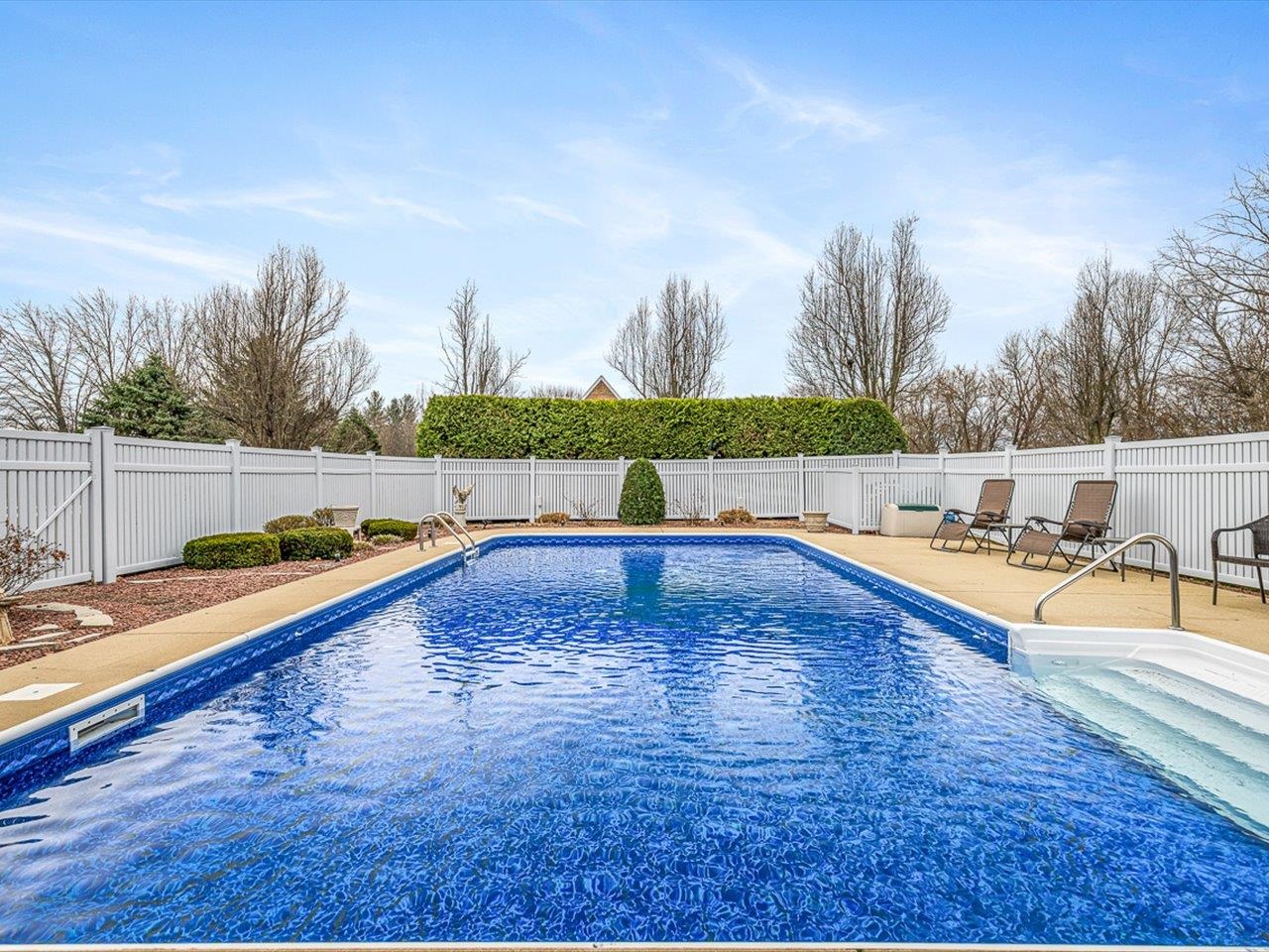 9744 Prairie Lane Belvidere, IL 61008 - Photo 47 of 66 a view of a swimming pool with an outdoor seating and a garden