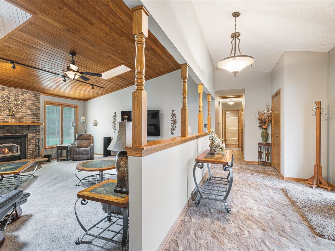 9744 Prairie Lane Belvidere, IL 61008 - Photo 7 of 66 a living room with furniture a fireplace and a chandelier