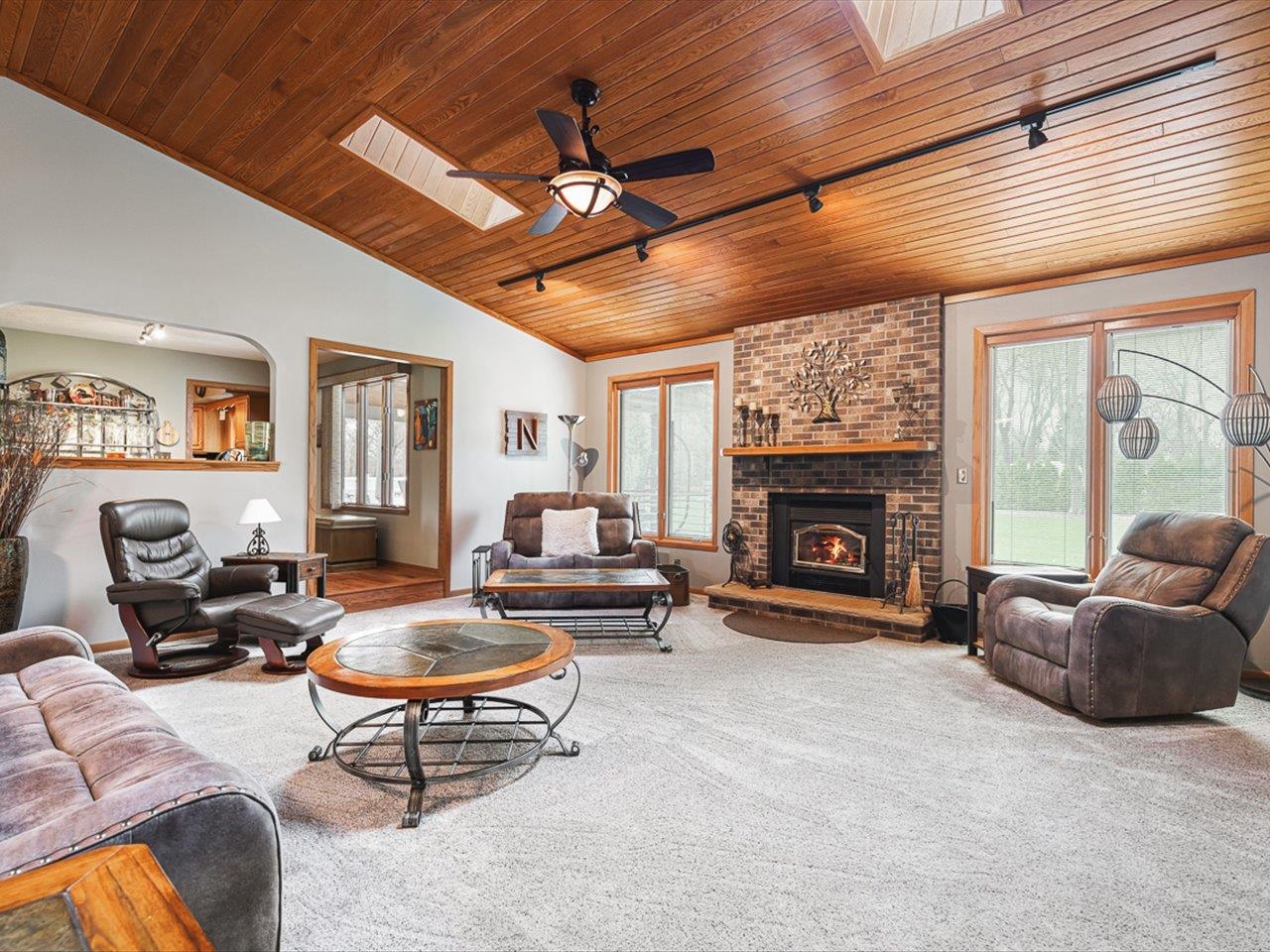9744 Prairie Lane Belvidere, IL 61008 - Photo 8 of 66 a living room with furniture a fireplace and a table