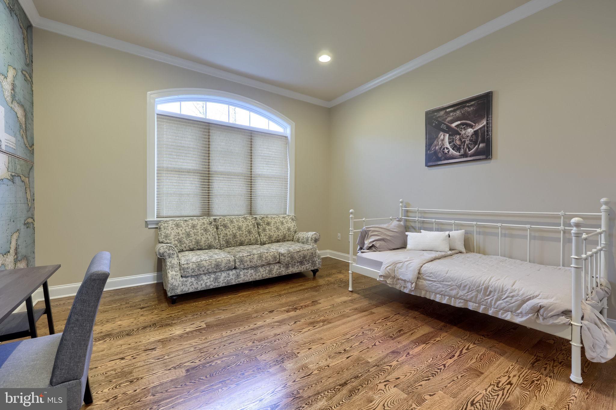 521 Meetinghouse Road Gap, PA 17527 - Photo 30 of 79 a bedroom with a bed a couch and a potted plant