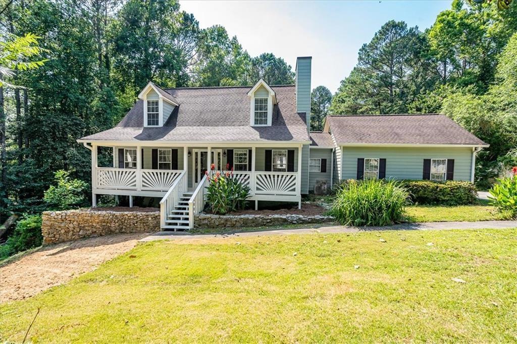 4264 Timber Trace Road Loganville, GA 30052 - Photo 1 of 1 a front view of house with yard and swimming pool
