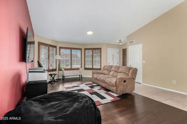 a living room with furniture and large windows