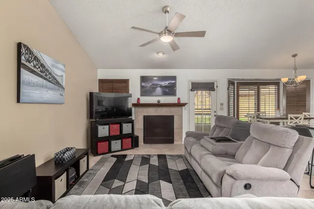 a living room with furniture fireplace and flat screen tv