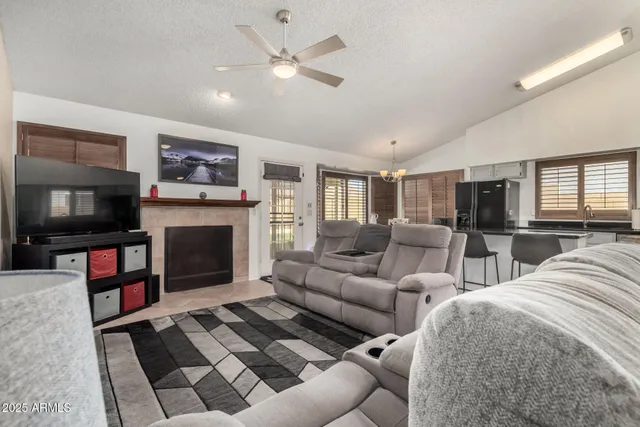 a living room with furniture a flat screen tv and a fireplace