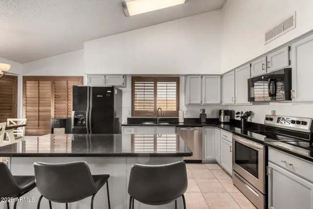 a kitchen with granite countertop a sink and cabinets