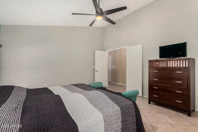 a bedroom with a bed and a television