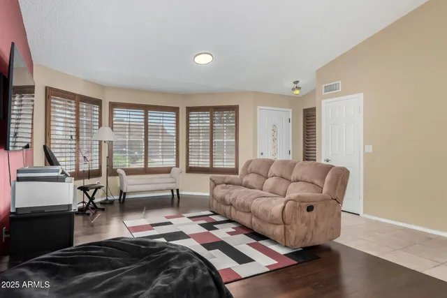a bedroom with furniture and a large window