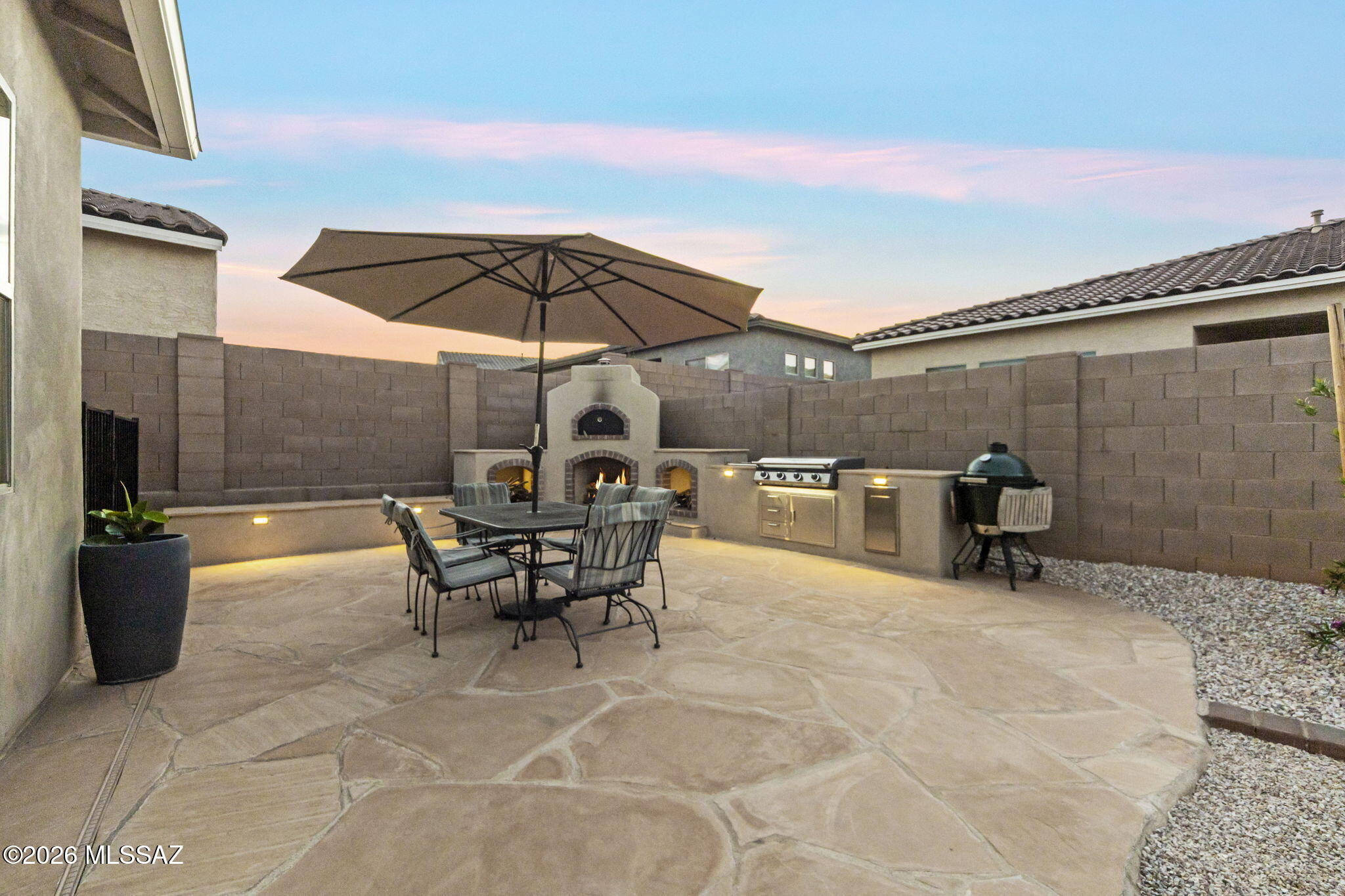 12791 East Tortoise Pointe Drive Vail, AZ 85641 - Photo 46 of 50 a view of a patio with a table and chairs under an umbrella