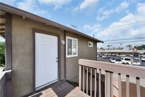 a view of a porch with wooden floor and fence