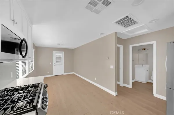 a view of a livingroom with wooden floor and a ceiling fan