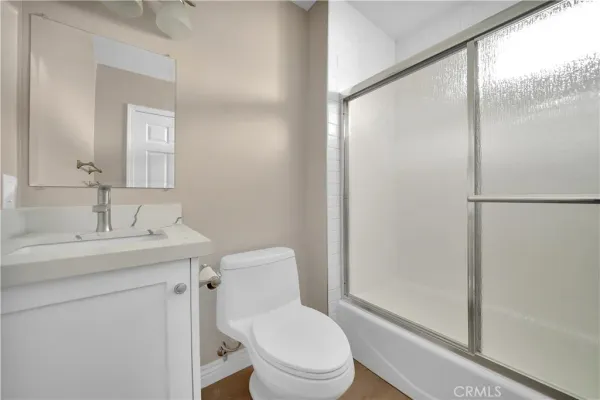 a bathroom with a toilet a sink and a mirror