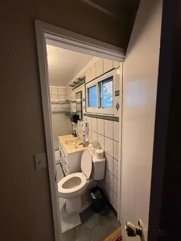 a white toilet sitting next to a small bathroom