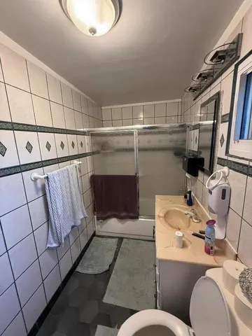 a bathroom with a sink mirror and toilet